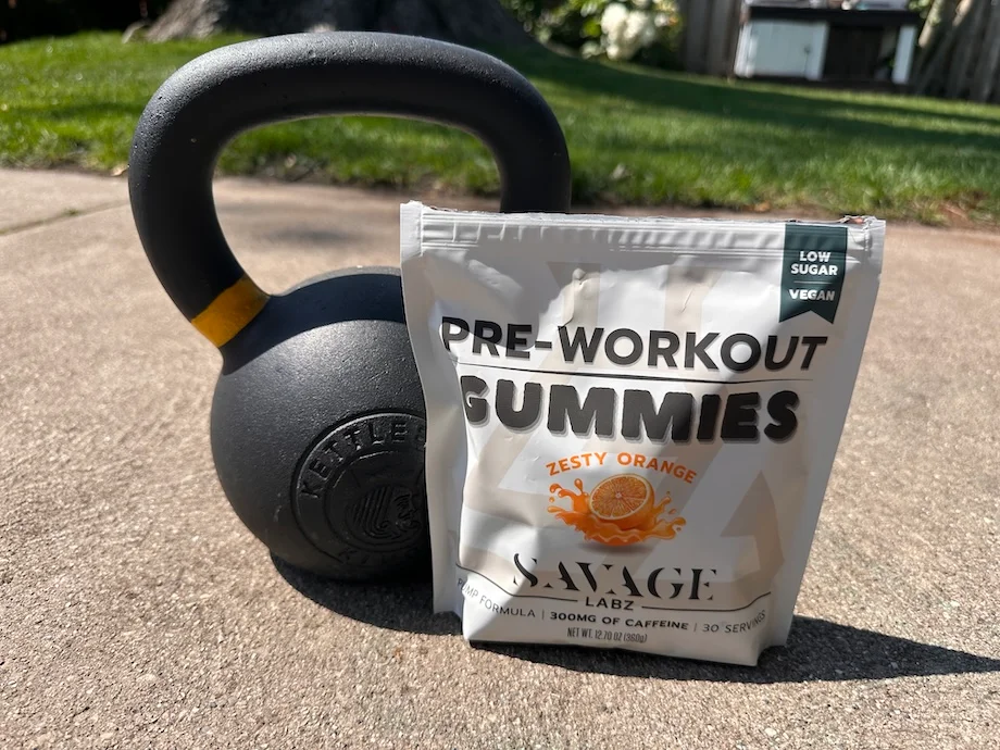 Pouch of Savage Labz Pre-Workout Gummies next to a kettlebell