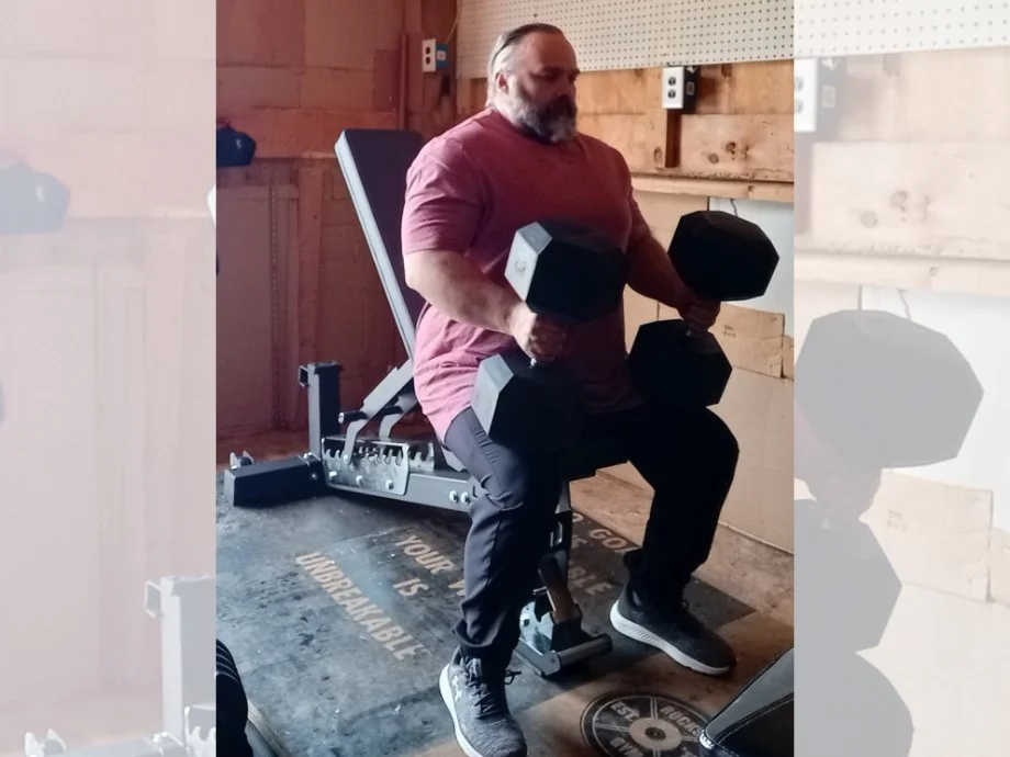 A man is shown using the DMoose Adjustable Bench