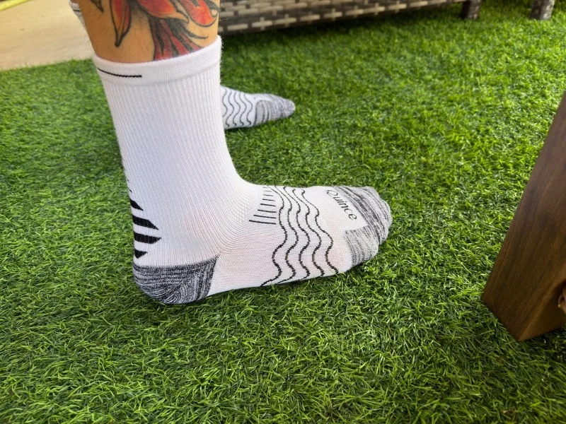 side view of quince running socks