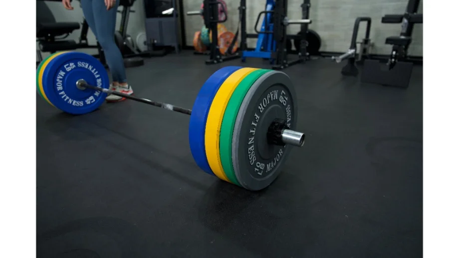 A barbell on rubber flooring with Major Fitness Bumper plates