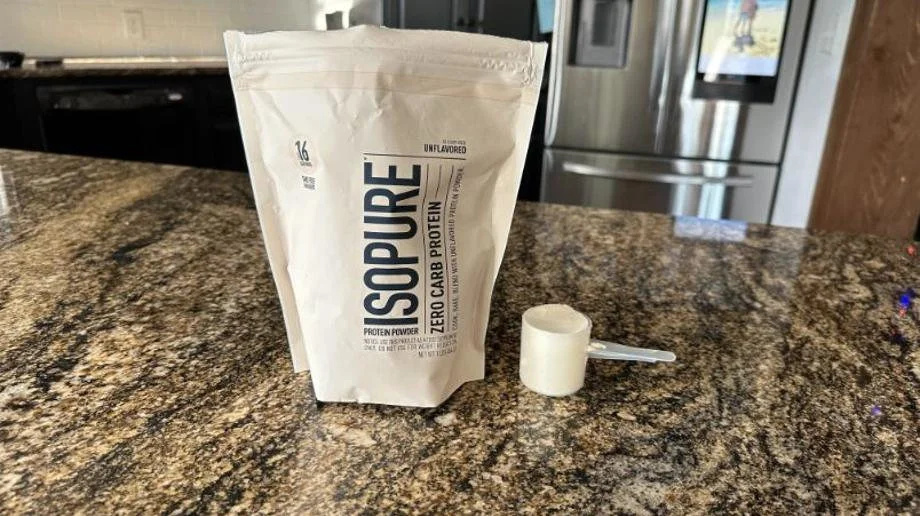 Isopure Protein Whey Unflavored with a scoop next to the bag
