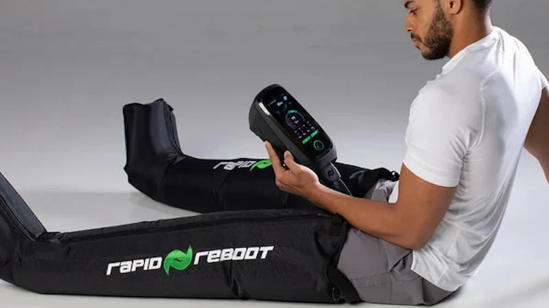 Man sitting with Rapid Reboot compression boots on